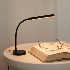 Slim USB reading light casting a warm glow beside a book